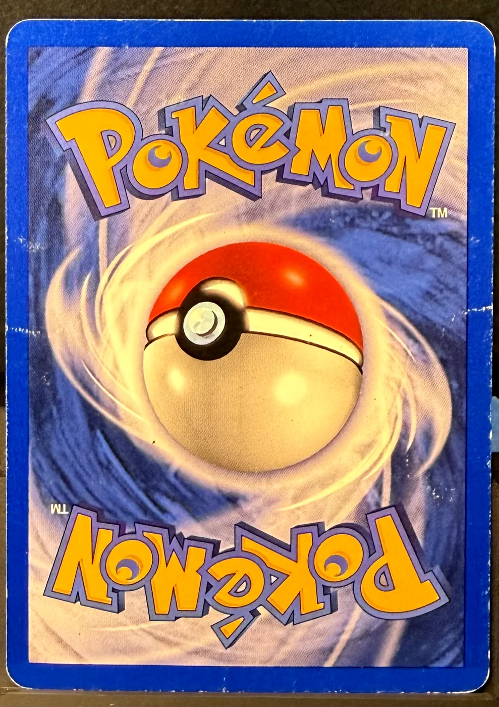 Back of a Pokémon card in Damaged condition.