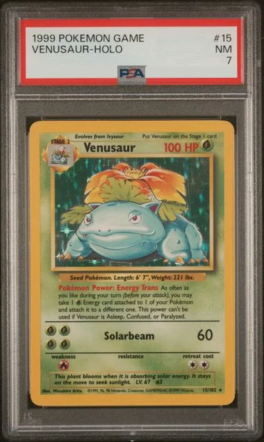 PSA 7 Venusaur holo from the 1999 Base Set. The PSA label reads 1999 POKEMON GAME, VENUSAUR-HOLO with no printing qualifier. There is no stamp, and the illustration window carries a drop shadow.
